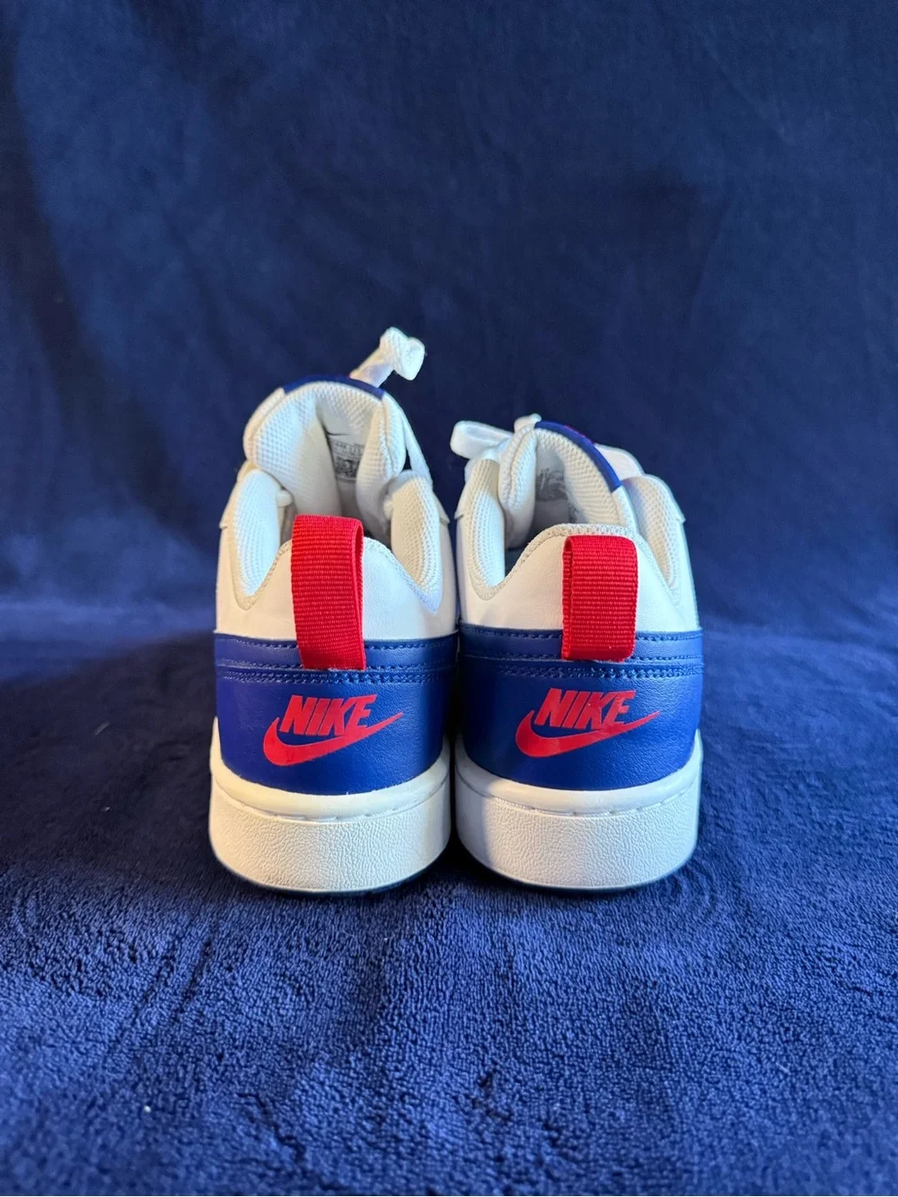 Nike Kids White Sneakers with Blue Swoosh and Red Heel Tab